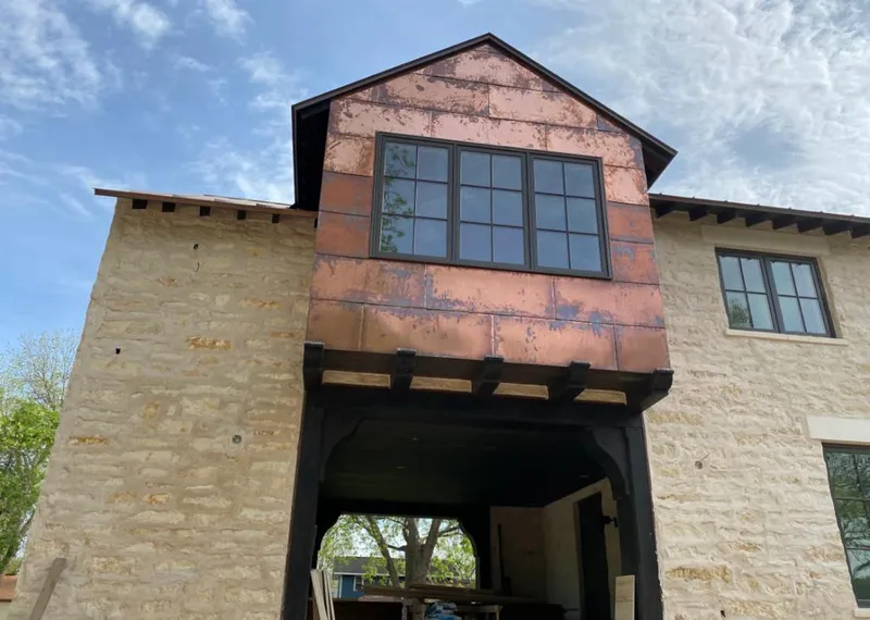 Copper metal panel facade on a stone building for Skylight Installation in Cold Springs